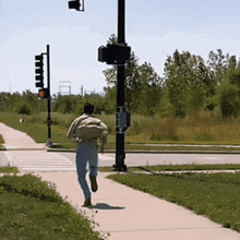 a man walking on a sidewalk with a backpack on his back