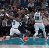 a group of basketball players are playing on a court .