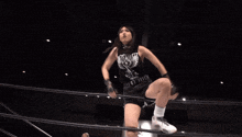 a woman stands in a wrestling ring with a sign that says storm