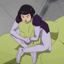 a cartoon character is sitting on a green couch with her hands on her stomach