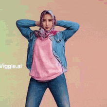the woman is wearing a hijab and a denim jacket .