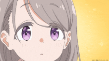 a close up of a girl 's face with purple eyes and a yellow background that says ' a ' on it