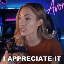 a woman sitting in front of a microphone with the words i appreciate it on her face