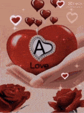 a person is holding a red heart with the letter a on it .