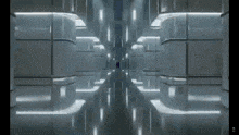a long hallway with a lot of lights on the walls