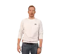 a man wearing a white sweater with the word alpha on the front