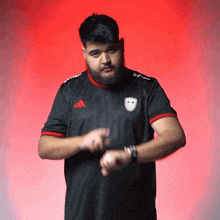 a man with a beard wearing an adidas shirt