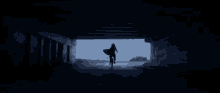 a person riding a bike in a dark tunnel with a surfboard
