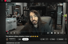 a man with long hair and a beard is talking on a youtube video