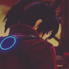 a close up of a person 's face with a blue circle on their back