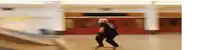 a person riding a skateboard in a room with a red door
