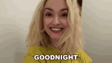 a woman in a yellow shirt is smiling with the words goodnight above her