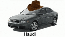 a cowboy hat is on top of an audi car