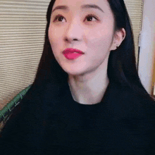 a close up of a woman 's face with red lipstick