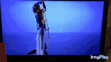 a samsung television shows a person standing on a ladder