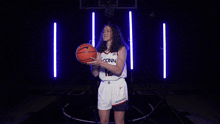 a female basketball player wearing a jersey that says iconn 12