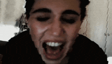a close up of a person 's face with their mouth wide open