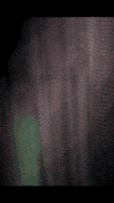 a blurred image of a person standing in the dark
