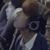 a man wearing a headset is looking up at something
