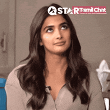 a woman is looking up in front of a star tamil chat banner