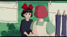 a girl with a red bow on her head is standing next to a woman