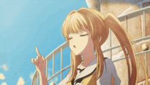 a girl with blonde hair is pointing her finger upwards