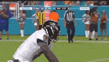 a football player is kneeling down on the field during a game