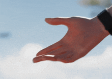 a close up of a person 's hand reaching out towards something