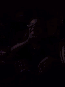 a man with glasses is laying on a couch with his hand on his face