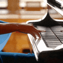 a person playing a piano with their left hand