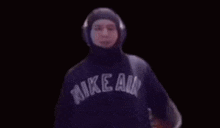 a person wearing a hoodie and headphones is dancing .