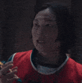 a man in a red and green shirt with the number 123 on it