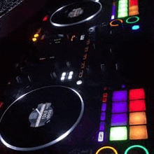a dj controller is sitting on top of a table with a keyboard .