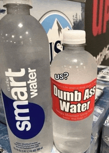 a bottle of dumb ass water next to a smart water bottle