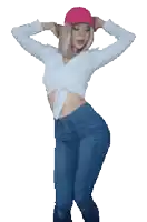 a woman wearing a pink hat and a crop top is dancing
