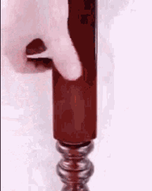 a person is opening a bottle of wine with a screwdriver .