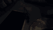 a dark room with a yellow stripe on the floor and a water cooler