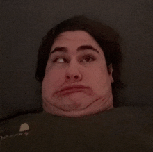 a man is making a funny face with his eyes closed and a shirt that says abercrombie & fitch on it