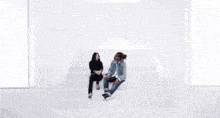 a man and a woman are standing next to each other and looking at each other .
