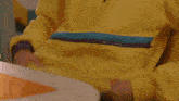a person wearing a yellow jacket is holding a yellow object