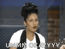 a woman is sitting in a chair and saying ummm okay yy .