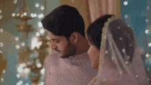 a man and a woman are standing next to each other in a room
