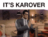 a man in a suit and tie applauds with the words it 's karover