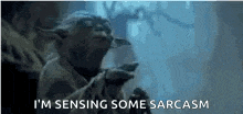 yoda from star wars is saying `` i 'm sensing some sarcasm '' while holding a cup of coffee .