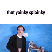 a man with glasses stands in front of a blue wall with the words that yoinky sploinky