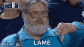a man with a beard and glasses is giving a thumbs down .
