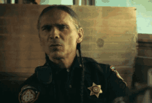 a man in a sheriff 's uniform has a badge on his shoulder that says washington