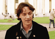 a man wearing a black jacket has a badge on his jacket that says ' a ' on it