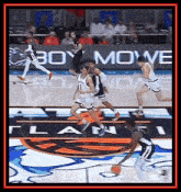 a basketball game is being played on a court with a boy move banner in the background
