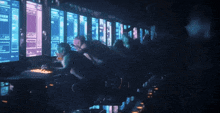 a group of people are sitting in front of a computer screen that says ' u.i.t. ' on it